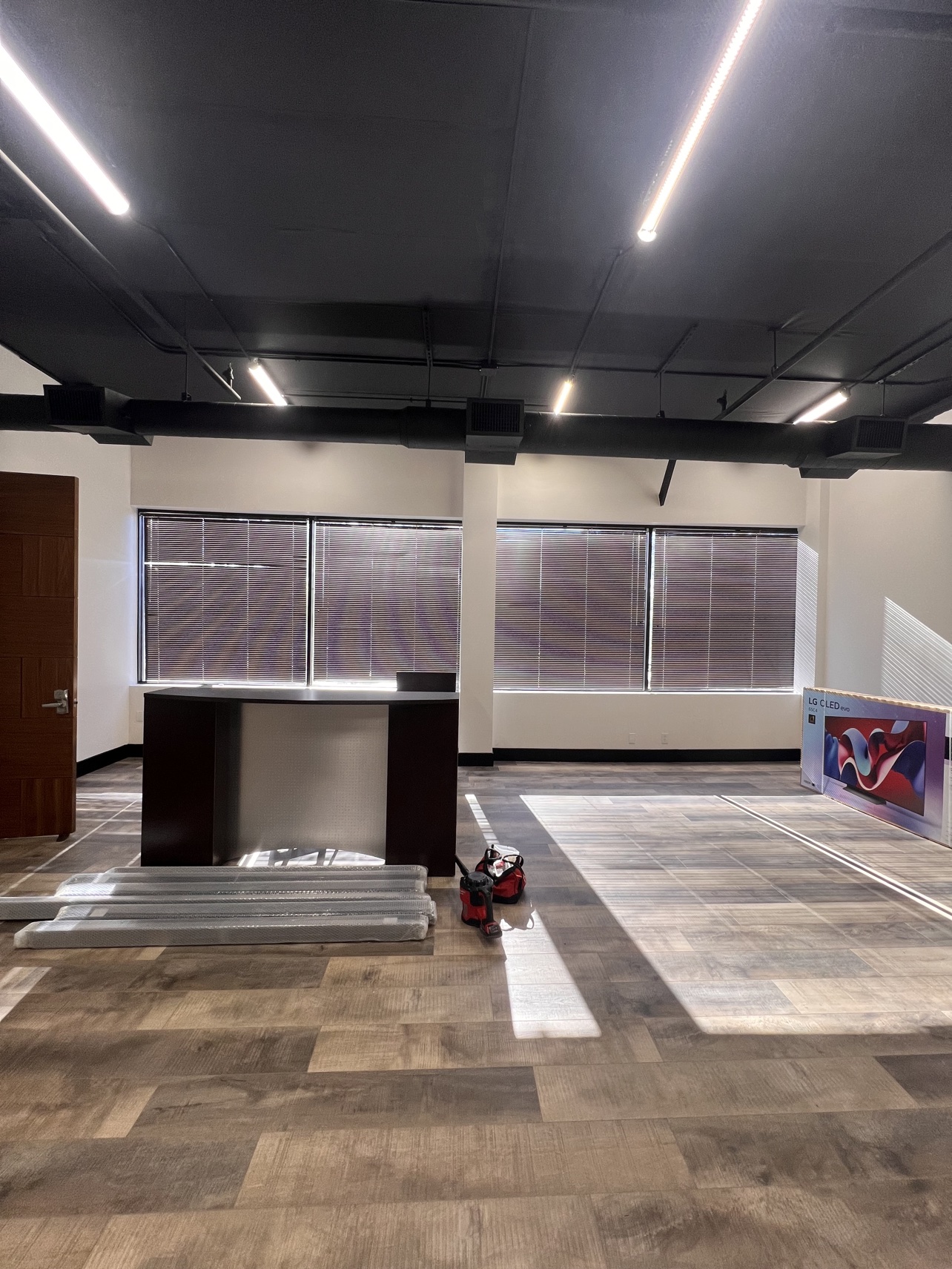 Before: the same reception area with dated blinds and harsh sunlight