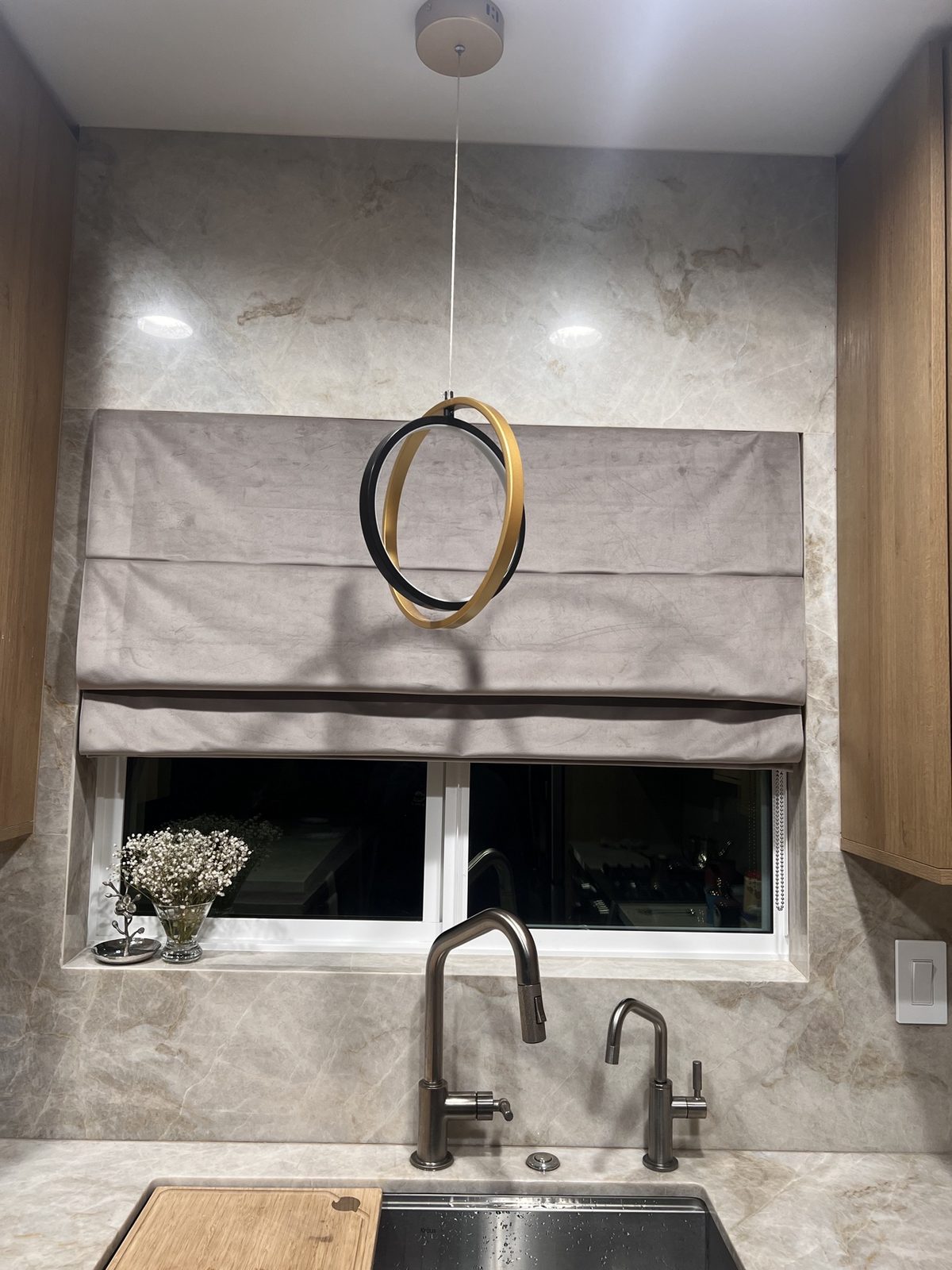 Real ShadeSpot install: gray Roman shade over a kitchen sink
