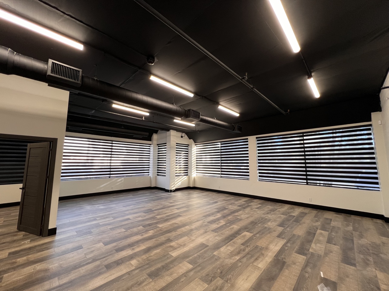 Open-plan office after blackout zebra shades were installed