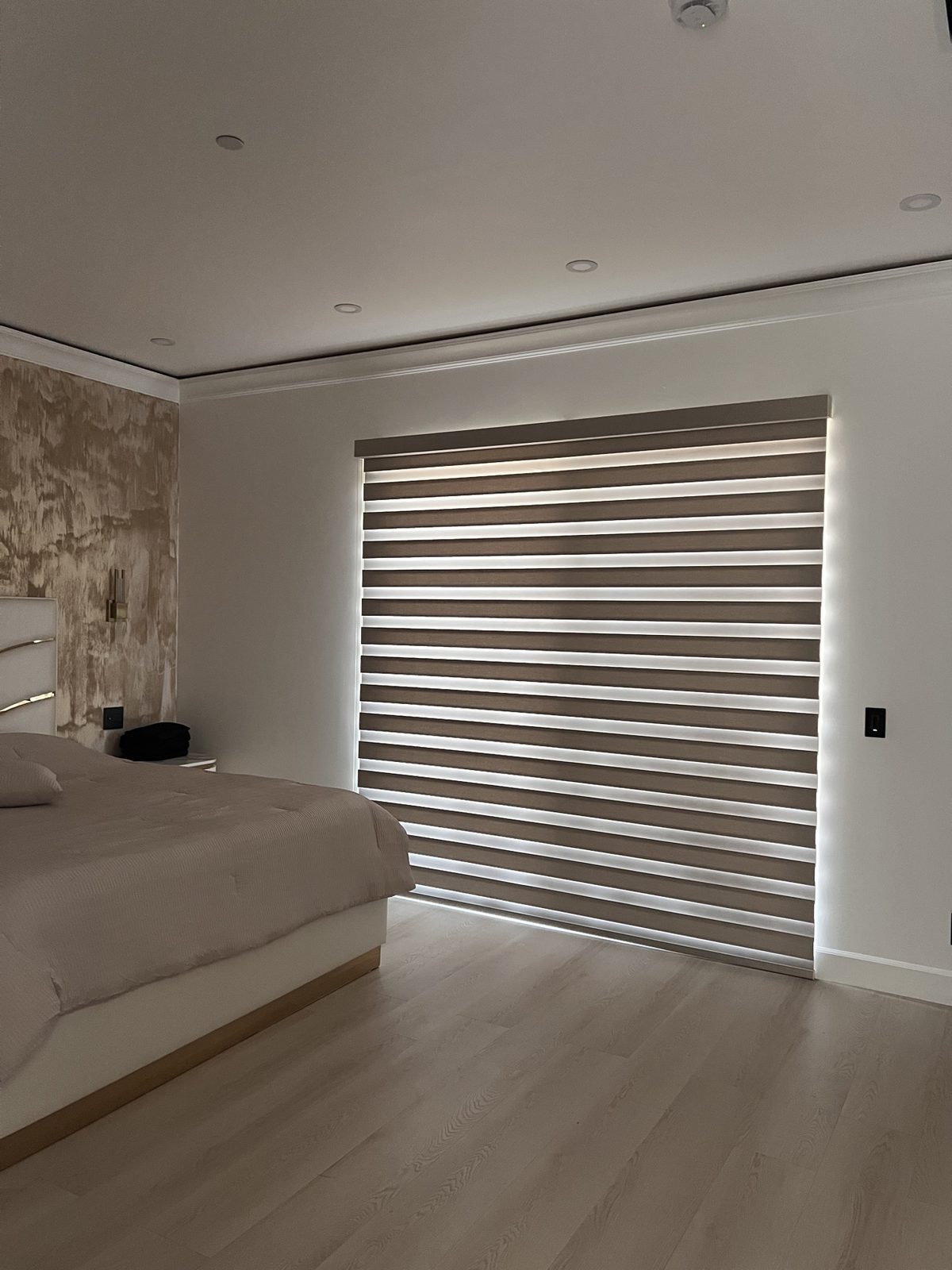 Real ShadeSpot install: wide blackout zebra shade across a bedroom window wall