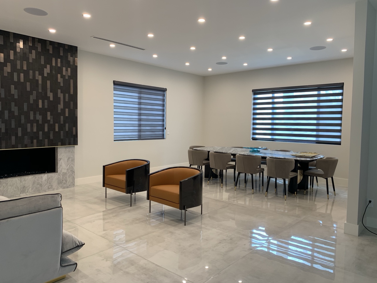 Real ShadeSpot install: light-filtering zebra shades in a marble-floor dining room